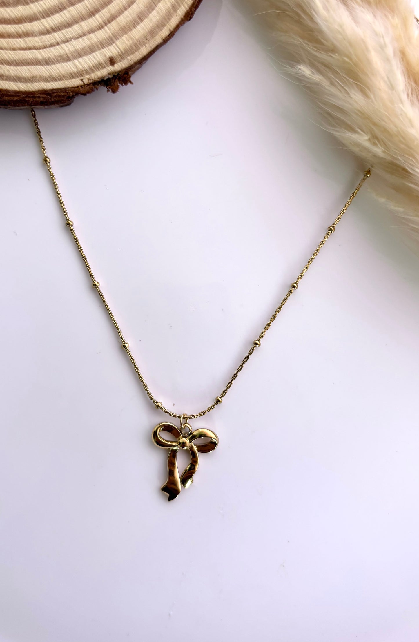 Anti tarnish gold plated bow pendant