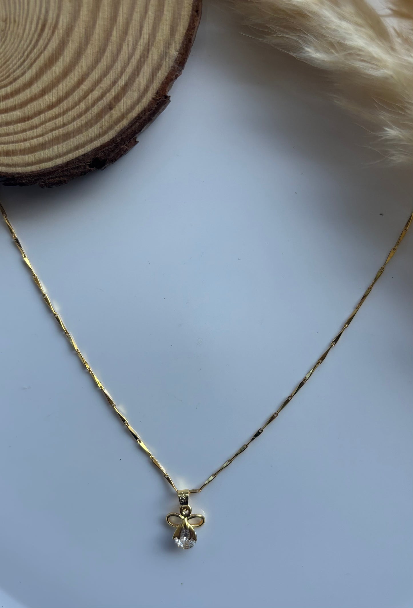 Anti tarnish gold plated bow with stone pendent